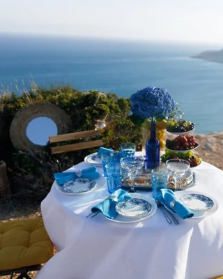 Blue-and-white table setting overlooking the sea
