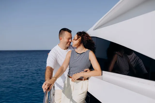 Serhiy and Anna together on a yacht with the blue sea behind them