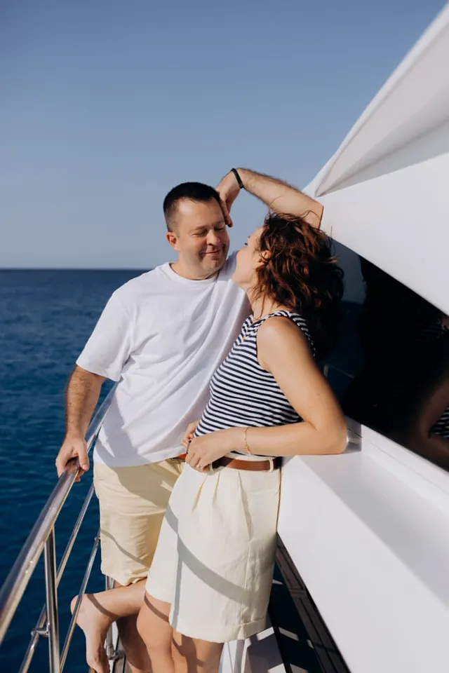 Serhiy and Anna sharing a moment beside the yacht railing