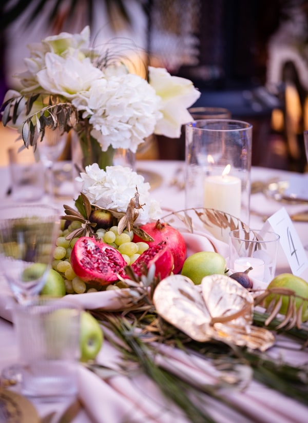 Chandeliers, flowers and fruit on the celebration tables