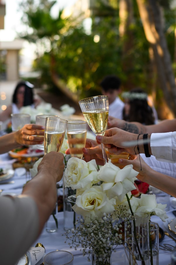 Wedding guests raising their glasses for a toast