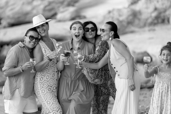 Guests chatting and posing together at the seaside picnic