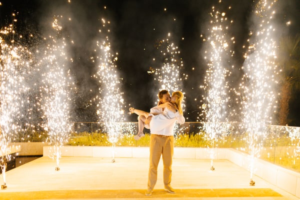 Anatoly lifting Valeria during their dance between fountains of sparks