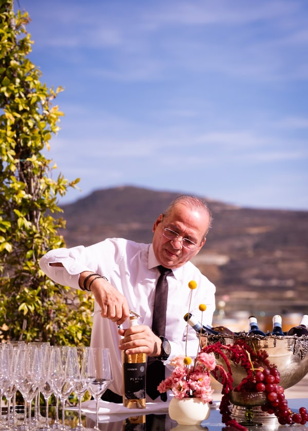 A bartender behind the outdoor bar