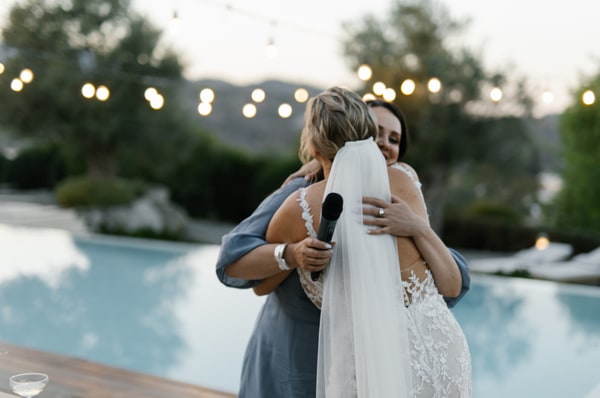 A warm embrace beside the pool as the evening lights come on