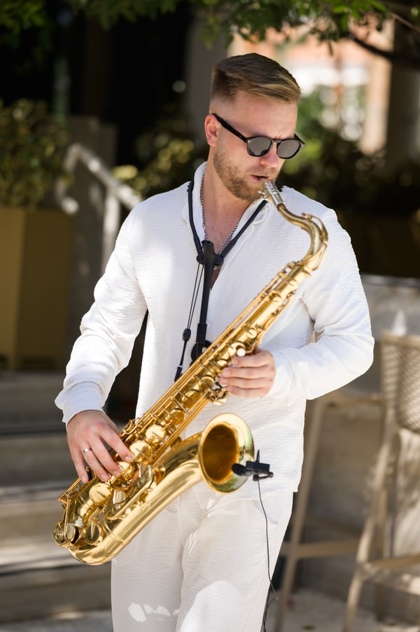 A saxophonist performing at the wedding