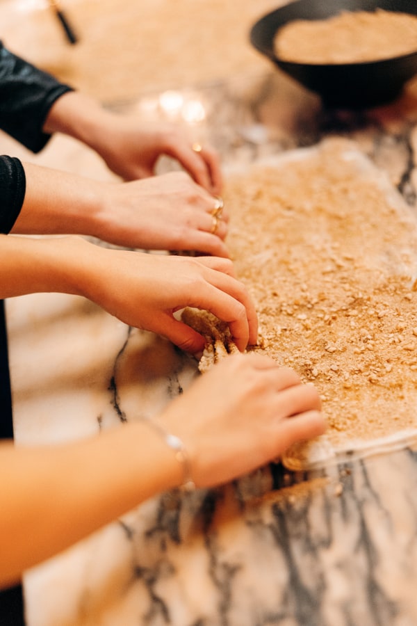 Guests making fresh pasta together in a kitchen