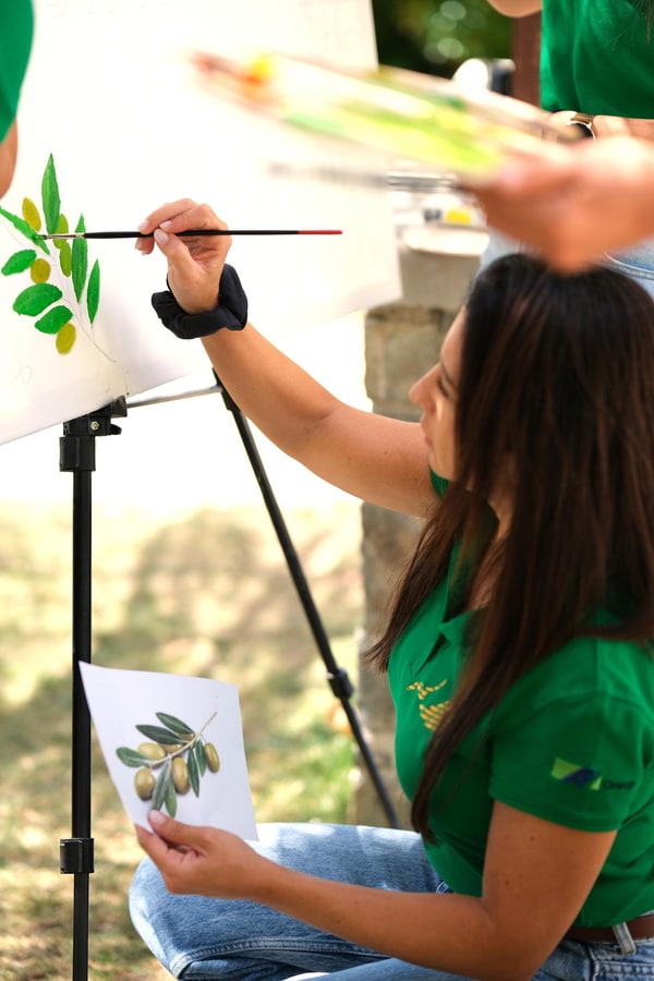 Participants painting together at outdoor easels