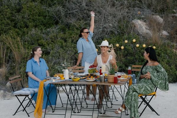 Guests chatting and posing together at the seaside picnic
