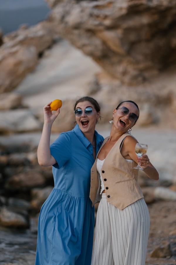 Guests chatting and posing together at the seaside picnic