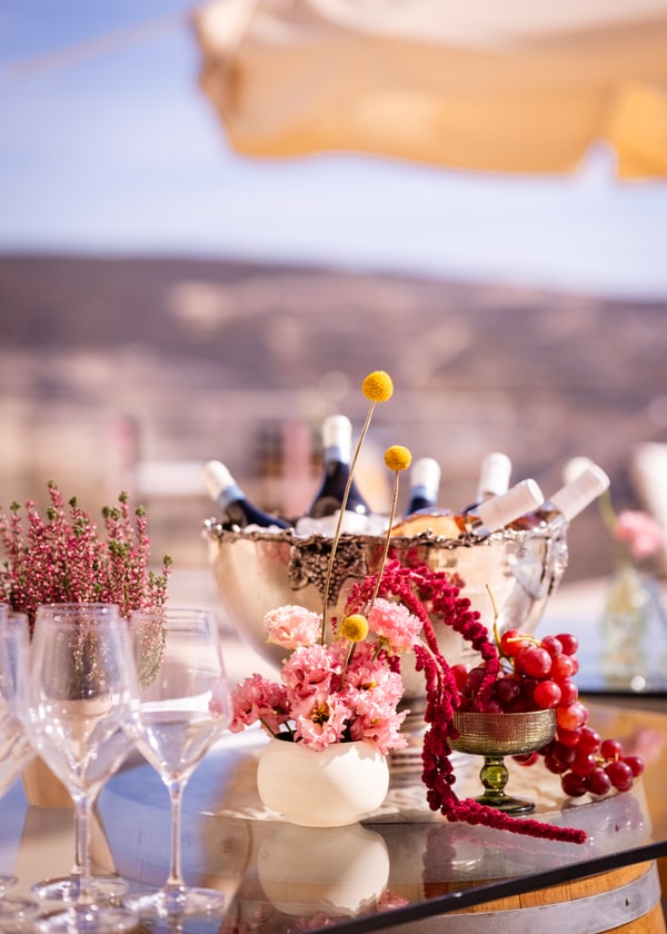 Glasses, bottles and grapes arranged at the bar