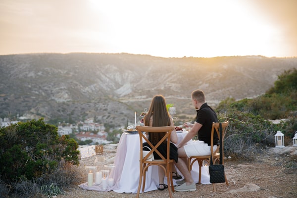 A couple together at the picnic table overlooking the bay
