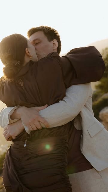 A couple embracing in warm sunset light