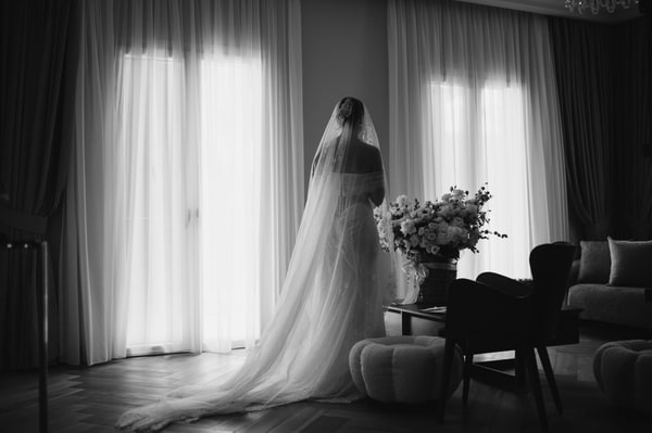 A bride in a veil preparing for the wedding