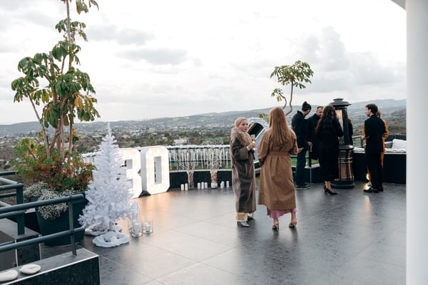 Guests on the terrace beside winter decorations