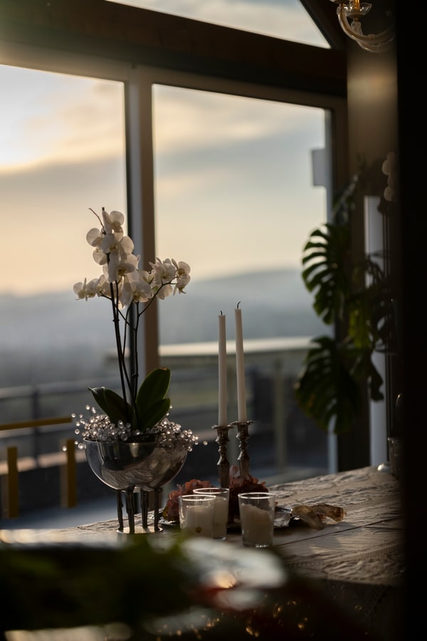 Orchids, candles and glasses on the dinner table
