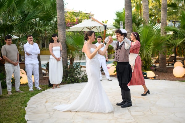 Performers and wedding guests dancing in the garden