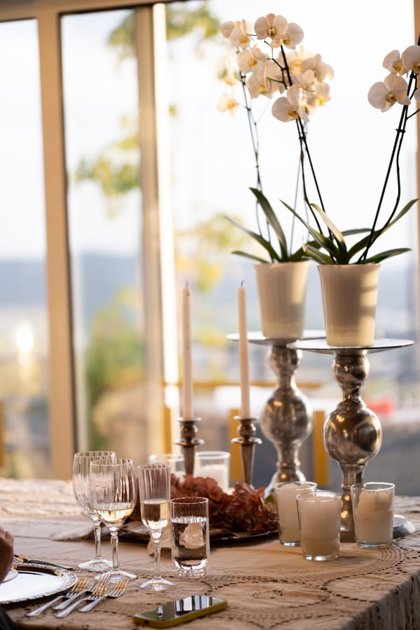 Orchids, candles and glasses on the dinner table