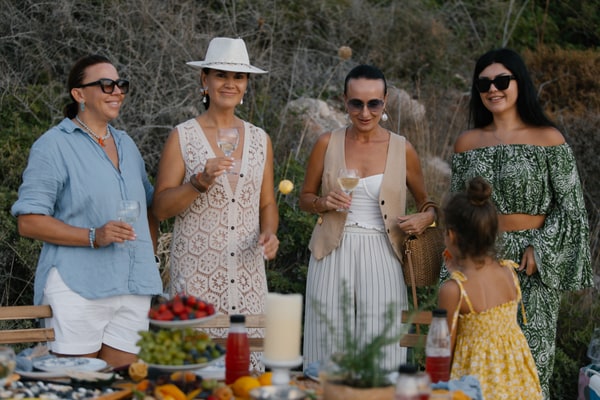 Guests chatting and posing together at the seaside picnic