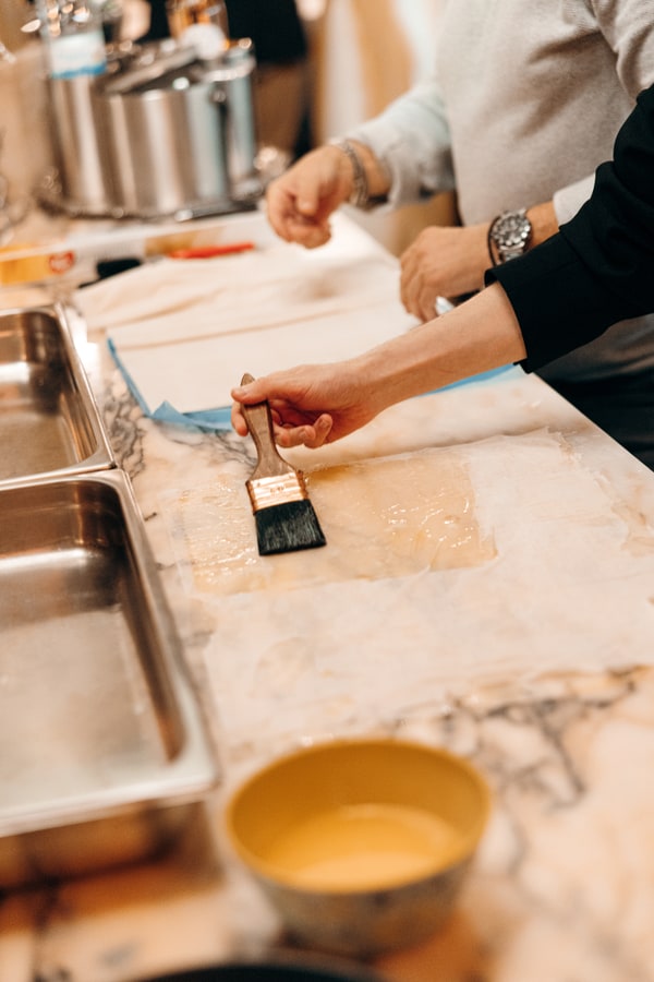 Guests making fresh pasta together in a kitchen