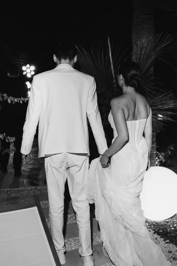 The newlyweds dancing together under evening lights