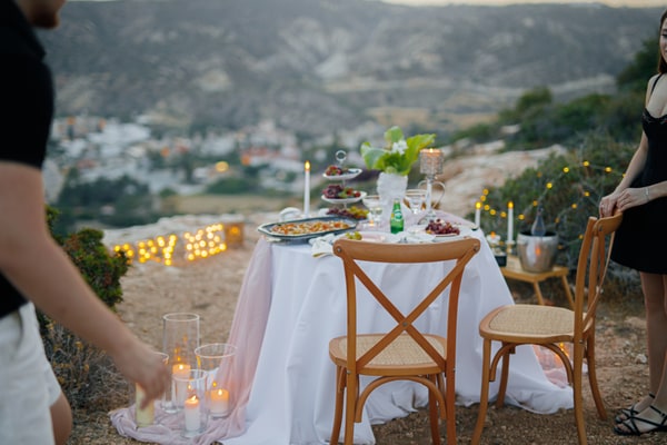 A couple together at the picnic table overlooking the bay