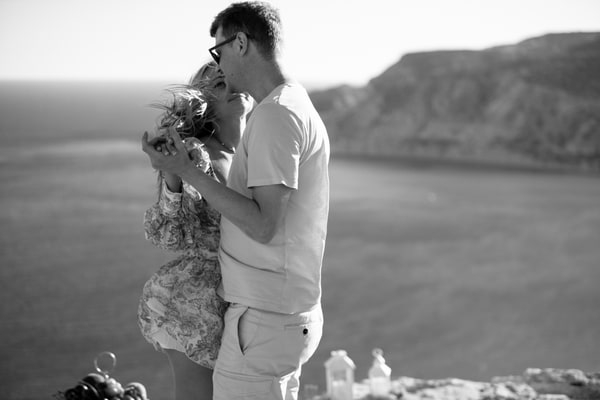 A couple enjoying live saxophone music above the sea