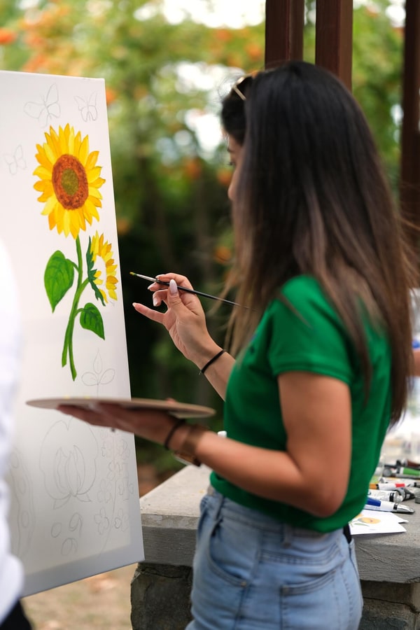 Participants painting together at outdoor easels