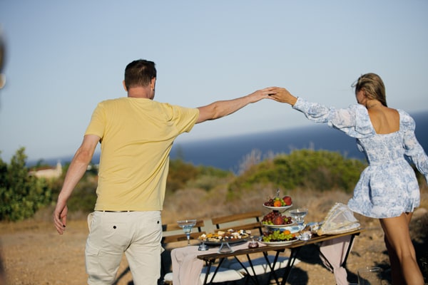 A couple dancing and embracing beside the sea