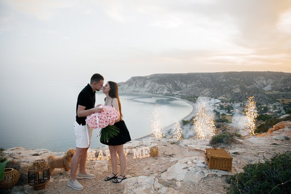The couple celebrating with pink roses and sparkling fountains