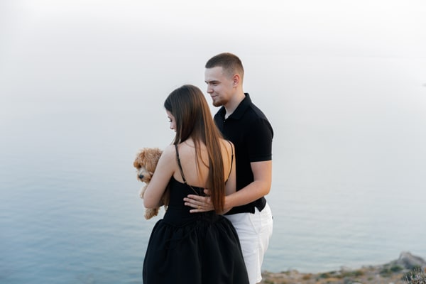 A couple embracing on the rocks above the sea