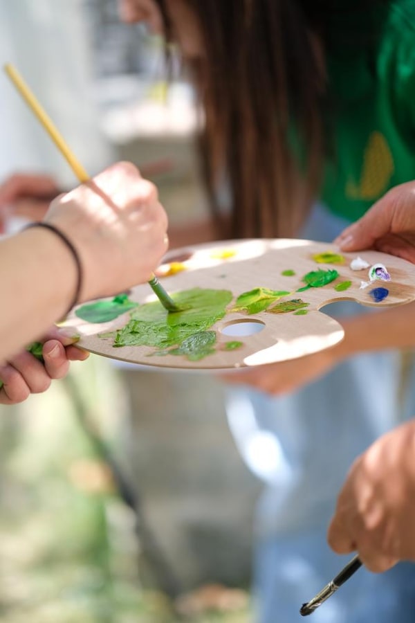 Participants painting together at outdoor easels