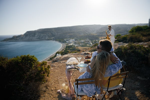 A couple enjoying live saxophone music above the sea