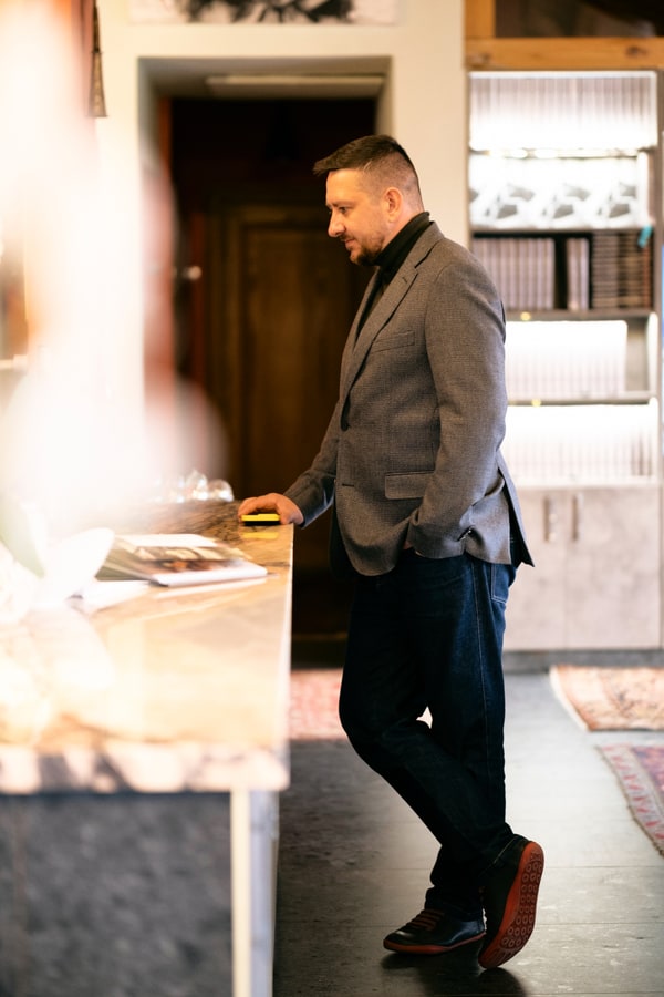 A man standing beside a table set for dinner