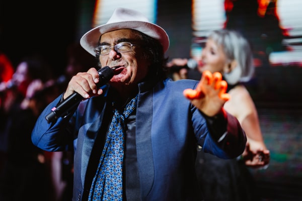 Singers performing under colourful stage lights
