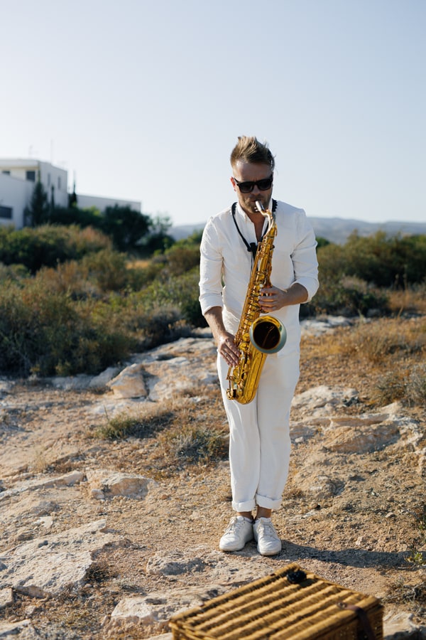 A saxophonist performing at the seaside picnic