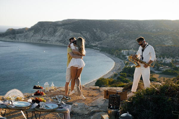 A couple enjoying live saxophone music above the sea