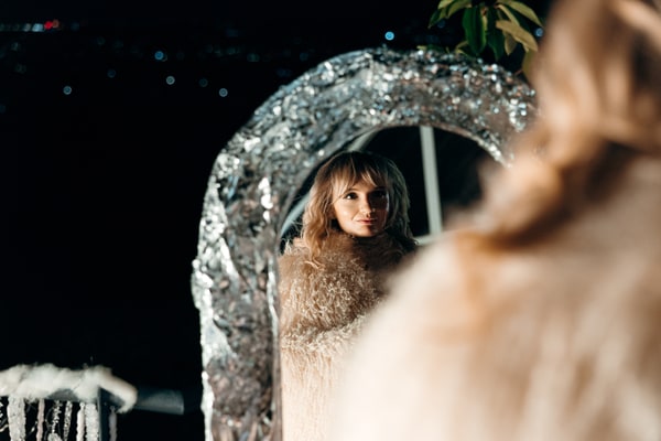 A portrait reflected in a silver-framed mirror