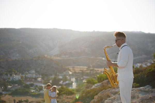 A saxophonist performing at the seaside picnic