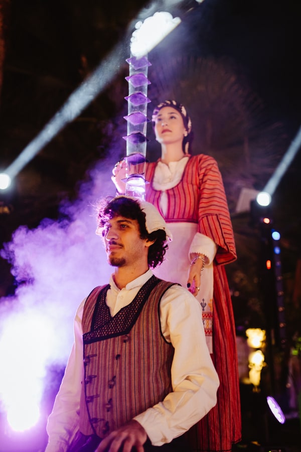 Performers and guests dancing beneath the evening lights