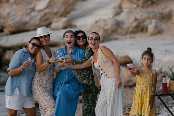 Guests chatting and posing together at the seaside picnic