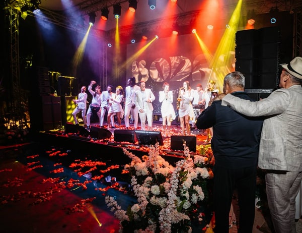 Singers performing under colourful stage lights