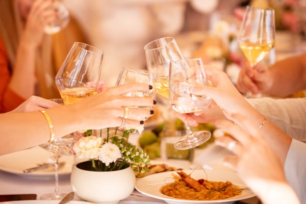 Guests raising glasses around the table