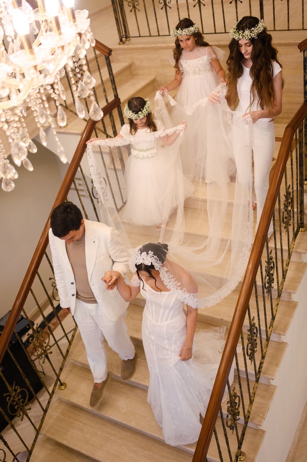 The bride and groom together on the flower-decorated staircase
