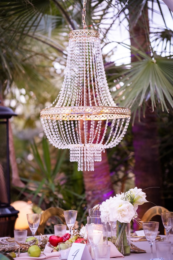 Chandeliers, flowers and fruit on the celebration tables