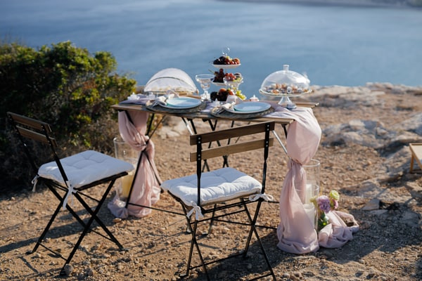 A seaside table with pale pink fabric and white place settings