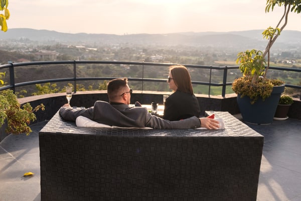 A couple seated outdoors overlooking the landscape