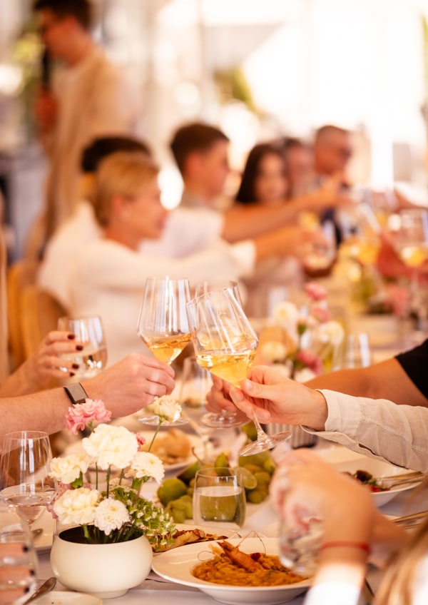 Guests raising glasses around the table