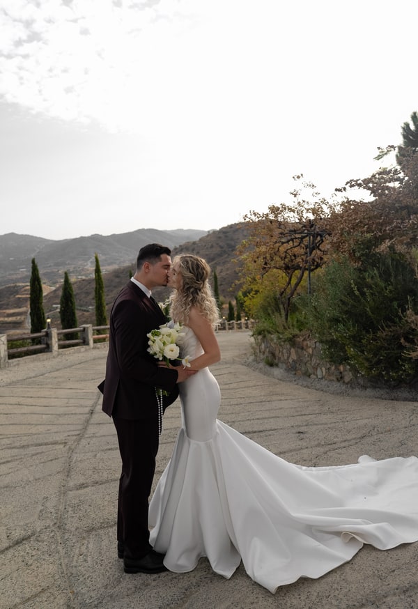 Darya and Andrey on a stone terrace overlooking the hills