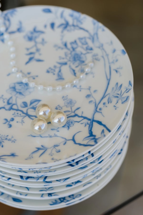 Pearl details resting on blue-and-white patterned plates